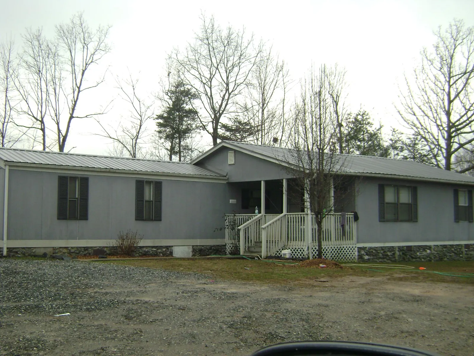 Metal roof over a manufactured home with a covered front porch in Woodburn